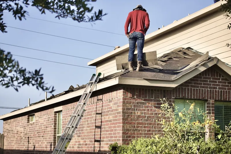 Professional roofer working on a residential roof in South Abington
